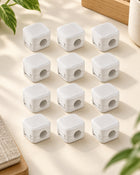 Twelve white magnetic cable organizers arranged as a complete set