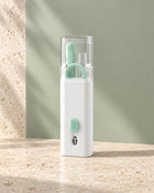 Closed Apple Green compact electronics cleaning kit in natural light